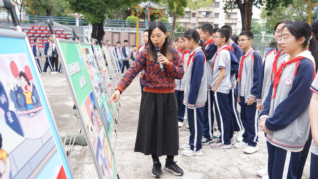 景贤学校的同学们在老师的讲解下参观漫画。